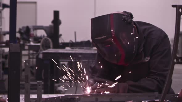 Super Slow Motion of Working Welder in Workshop