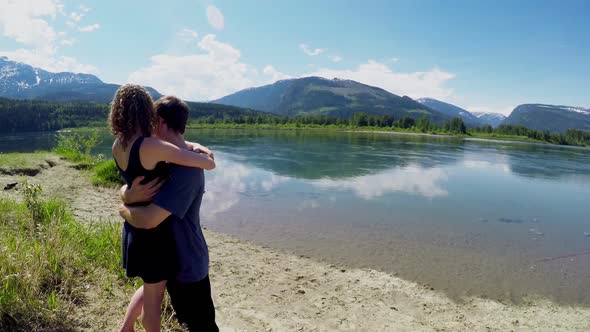 Couple hugging near lakeside