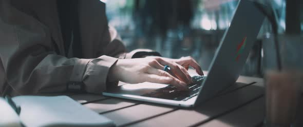 Young professional woman working on laptop and thinking