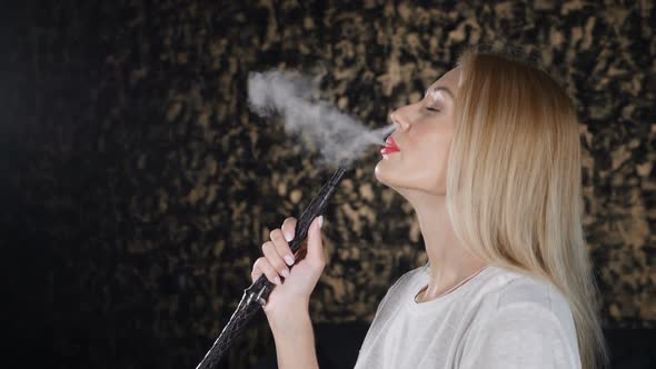 Smoke Being Breathed Out in Slow Motion By Attractive Woman in White Tshirt