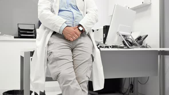 Portrait of Confident Doctor Crossing Hands and Smiling at Camera