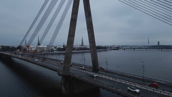 Many Cars Passing By Vansu Bridge in Gloomy Winter City of Riga Latvia