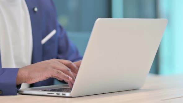 Close Up of Hands of African Businessman Typing on Laptop