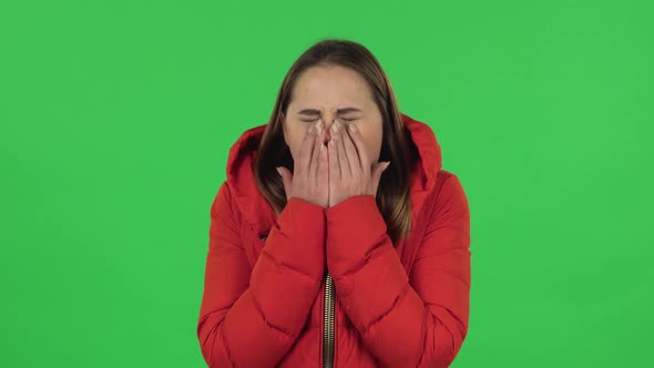 Portrait of Lovely Girl Carefully Examines Something Then Fearfully Covers Her Face with Her Hand