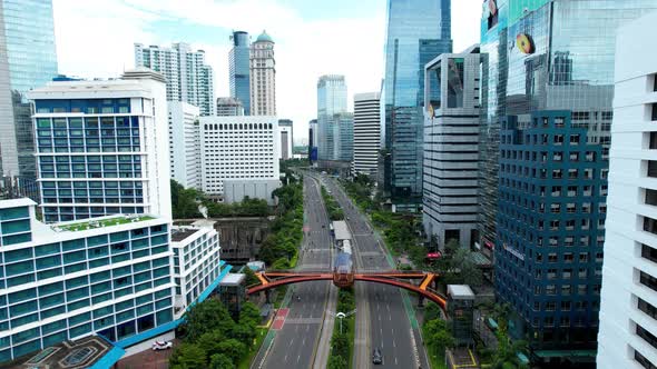 Aerial view of quiet traffic on Sudirman street with skyscrapers during weekend