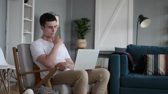 Pensive Man Thinking and Working on Laptop