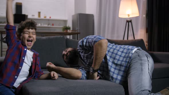 Father and Son During Arm Wrestling Competition