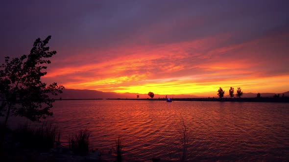 Colorful sunset over Utah Lake as the wind blows