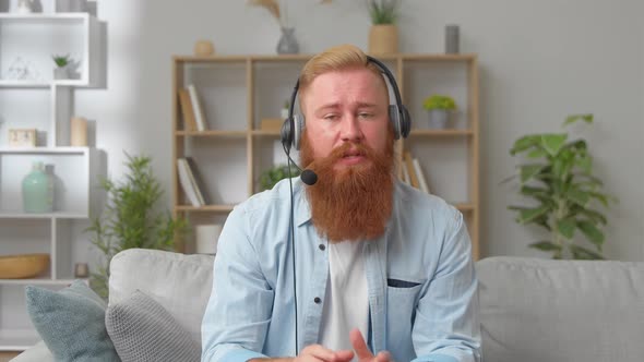 Web Camera Head Shot View Skilled Young Redhead Businessman Manager Boss in Headphones Holding