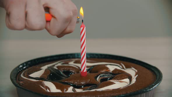 Lighting a Candle on a Cake with a Lighter