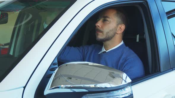 Smiling Man Examines Car Interior