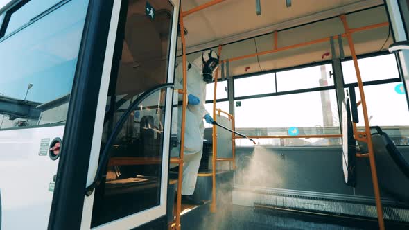 Interior of a Bus Is Being Chemically Disinfected By an Inspector. Coronavirus Prevention, Epidemic