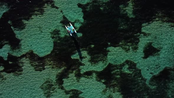 Yach in the Ocean Over Coral Reef