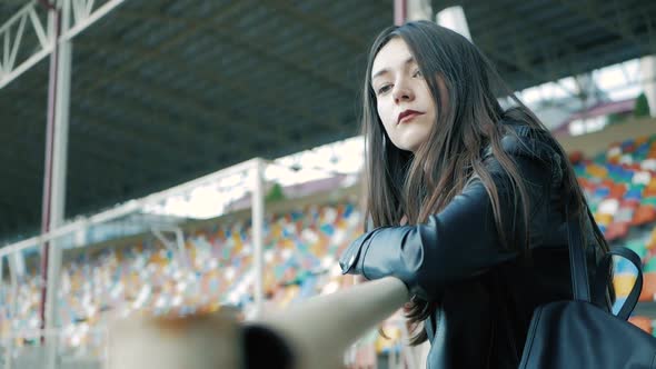 cool fashion serious teenage woman wearing in black, leather jacket, choker necklace with a long dar