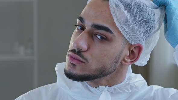 Portrait of Exhausted Tired Young Arab Male Doctor Nurse Practitioner in Protective Uniform Latex