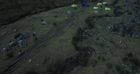 a revealing shot of a 6000m high snow covered mountain from the campsite