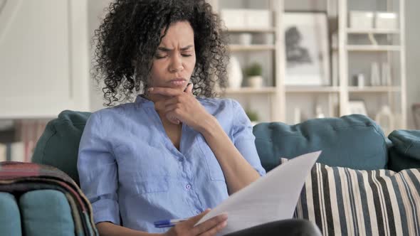 Tense African Woman Reading Documents