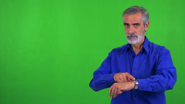 Old Senior Man Points on Watch (Show Time) - Green Screen - Studio
