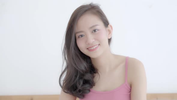 Portrait young asian woman with smiling and laughing in bedroom.