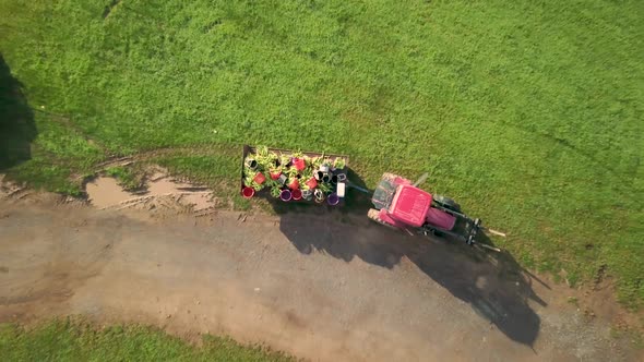 Aerial view of following tractor down country road in the rolling hills of West Virginia.