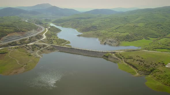 Aerial view of highway road in Techniti Limni Smokovou lake in Greece.