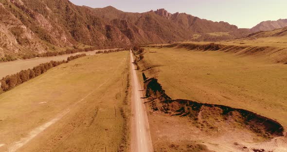 Aerial Rural Mountain Road and Meadow at Sunny Summer Morning