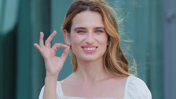 Happy European Caucasian Woman Gesturing Ok Smiling with White Teeth Looking at Camera Pretty