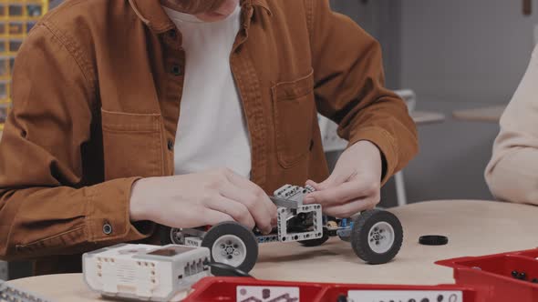 Boy Working On Car Model