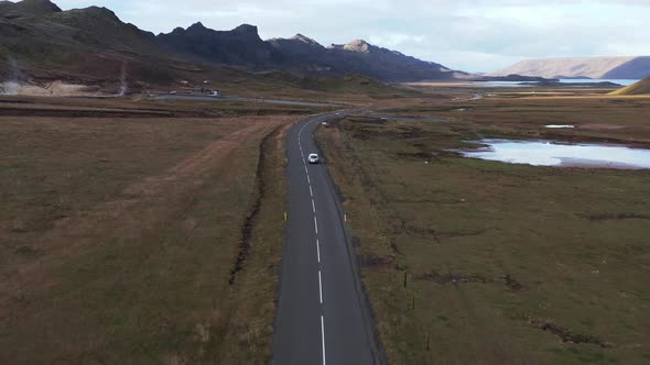 Car travels on valley road with amazing panoramic landscape on Reykjanes Peninsula, aerial