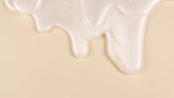 White Cosmetic Gel Fluid Cream With Molecule Bubbles Flowing On The Plain Beige Surface