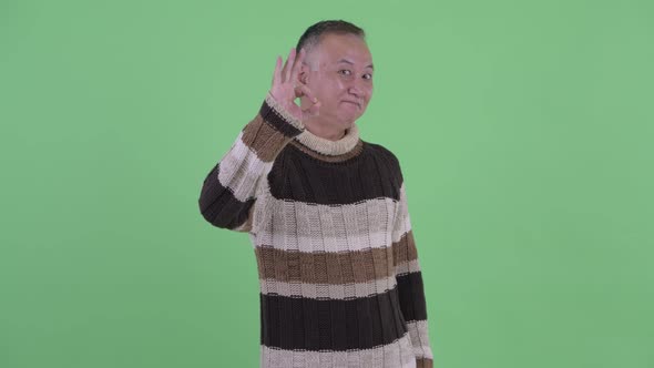 Happy Mature Japanese Man with Ok Gesture