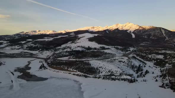 4K drone video of sunrise on the summit of the Rocky Mountains in Colorado during the winter.