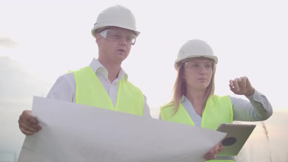 Coworking Engineers with Tablets on Solar Plant