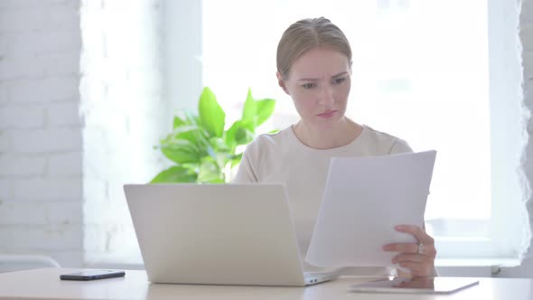 Woman Upset While Reading Business Report at Work