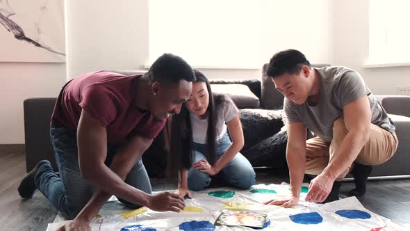 Diverse Group of Friends Plating Twister at Home