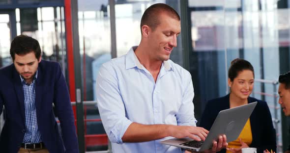 Business executive using laptop in office