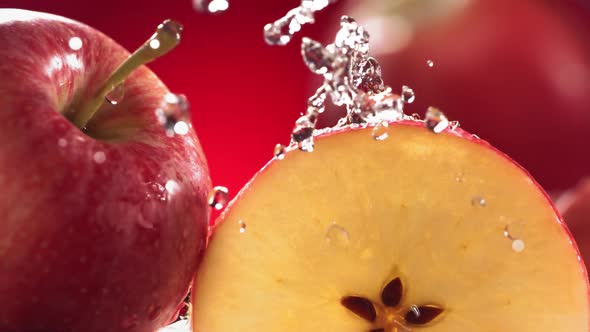 Slow Motion Shot of Red Apple Juice Splashing Through Apple Slices