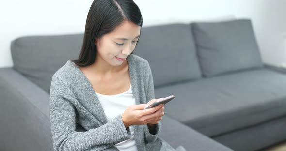 Woman sending sms on cellphone