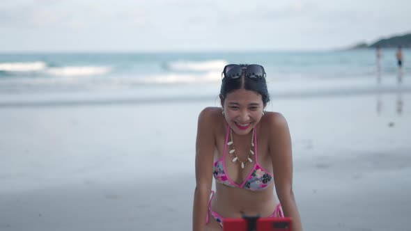 Thai Girl Having Fun Live Streaming From a Tropical Beach By the Sea