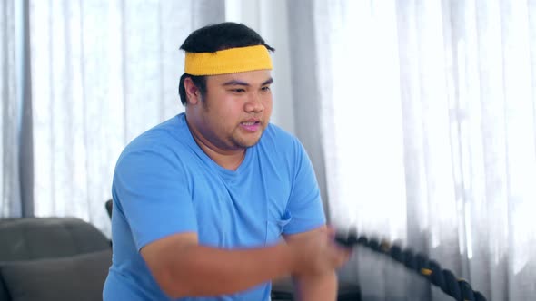 Asian Fat Man Practicing Battle Rope Exercise At Home, Fat Loss