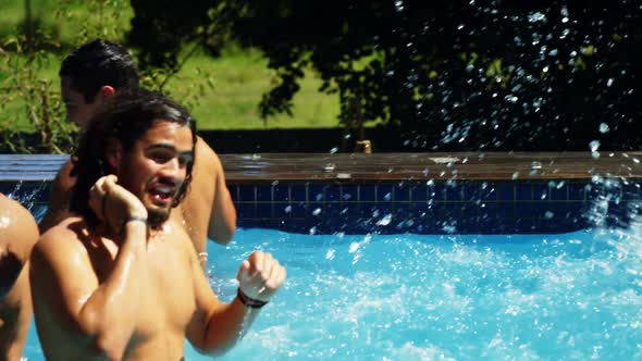 Group of friends having fun in swimming pool