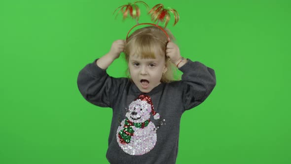 Happy Beautiful Little Girl in a Sweater with a Snowman. Christmas. Chroma Key