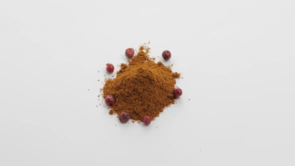 Red Pepper Powder Rotation. Macro Shot Against a White Background