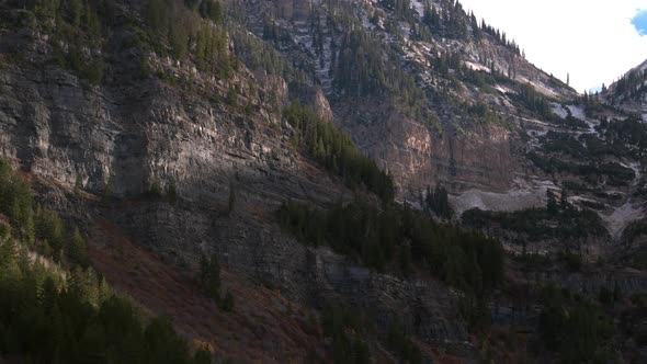 Aerial view of a beautiful mountainside and snowy cliffs in Utah.