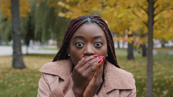Frustrated Stressed African American Millennial Girl with Wide Open Eyes Covering Mouth with Palm