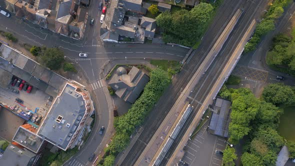 Train Departing a City Station at Sunset Aerial View