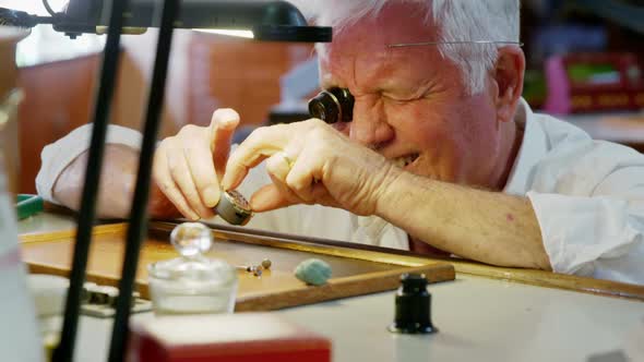 Horologist repairing a watch