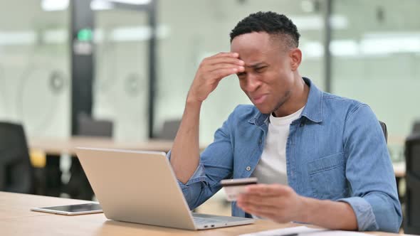 Casual African Man Having Online Payment Failure on Laptop