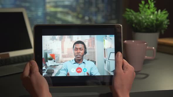 Tablet Screen with Video Calling to Mixedrace Businessman