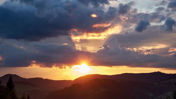 Colorful Clouds in Fast Motion Over Green Hilly and Forest Landscape in Summer